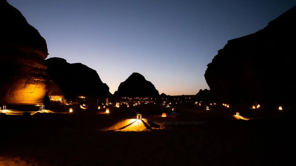 Lanterns lighting a desert valley between sandstone cliffs in AlUla at dusk