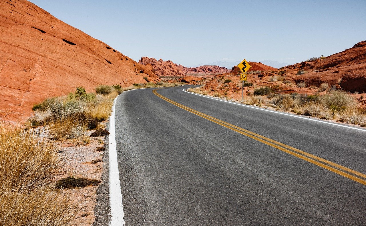 Desert road stretching through the barren landscape of northwest Saudi Arabia