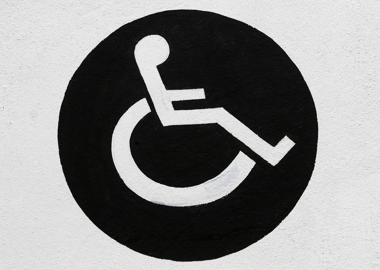 Accessible vehicle with a fold-out wheelchair ramp positioned for boarding