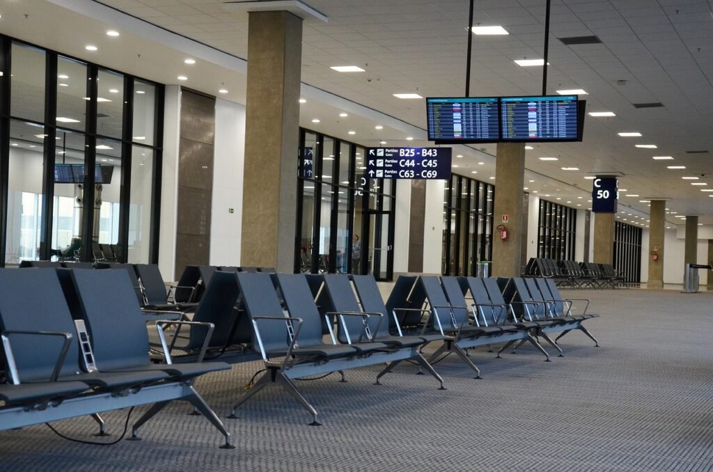 Business traveller being met by a driver holding a name sign at an airport arrivals hall