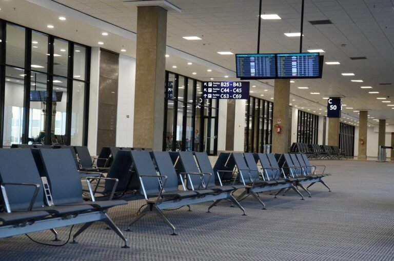 Business traveller being met by a driver holding a name sign at an airport arrivals hall