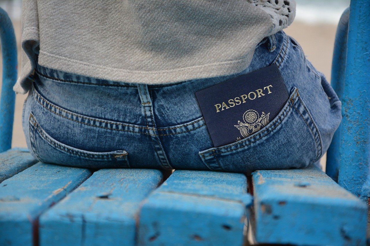 A passport and boarding pass, representing entry document preparation (wider view)