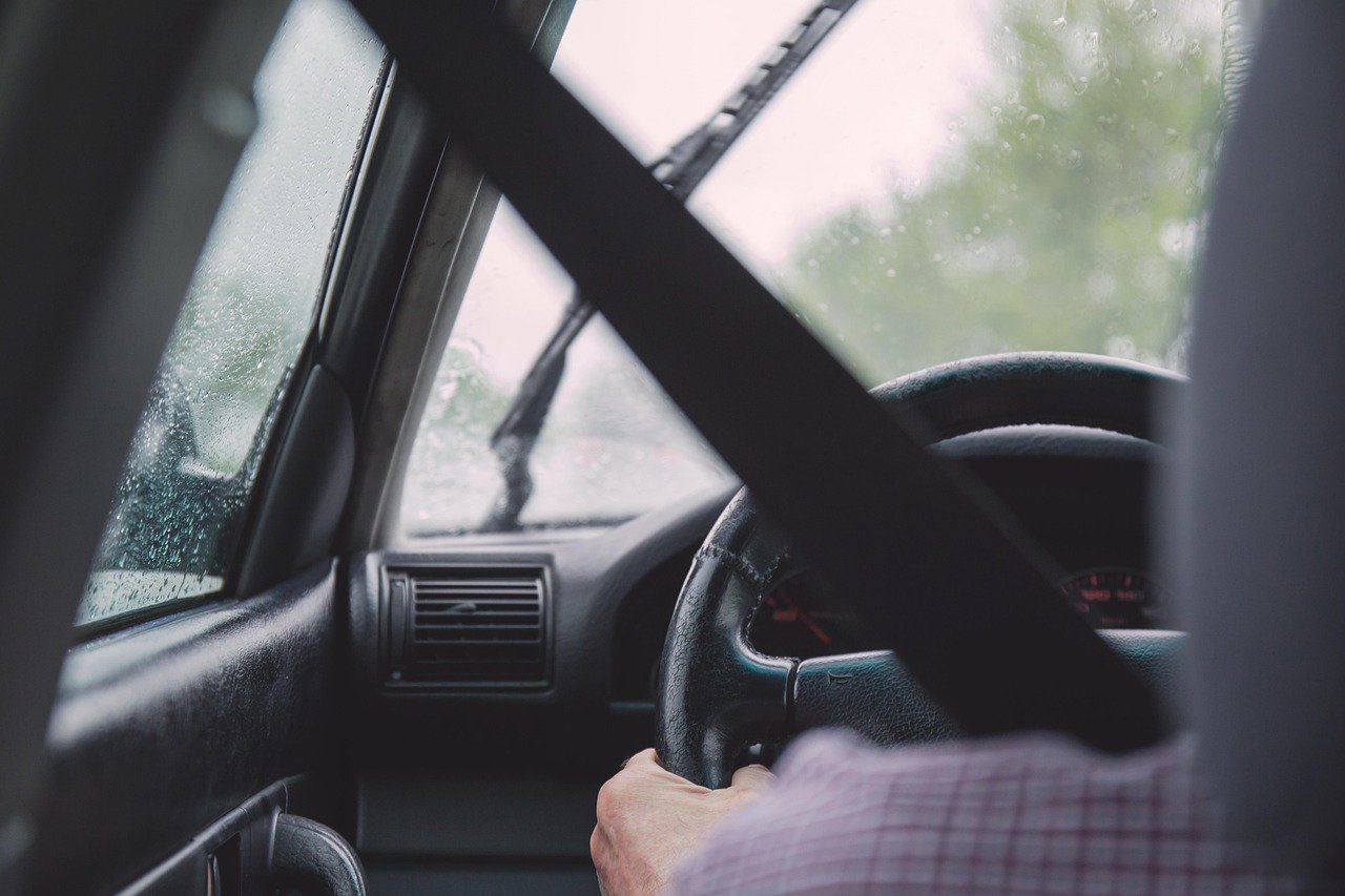 Dedicated driver standing beside a vehicle during a multi-day business trip