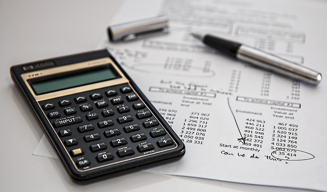 Insurance documents and vehicle keys laid out on a desk before a booking