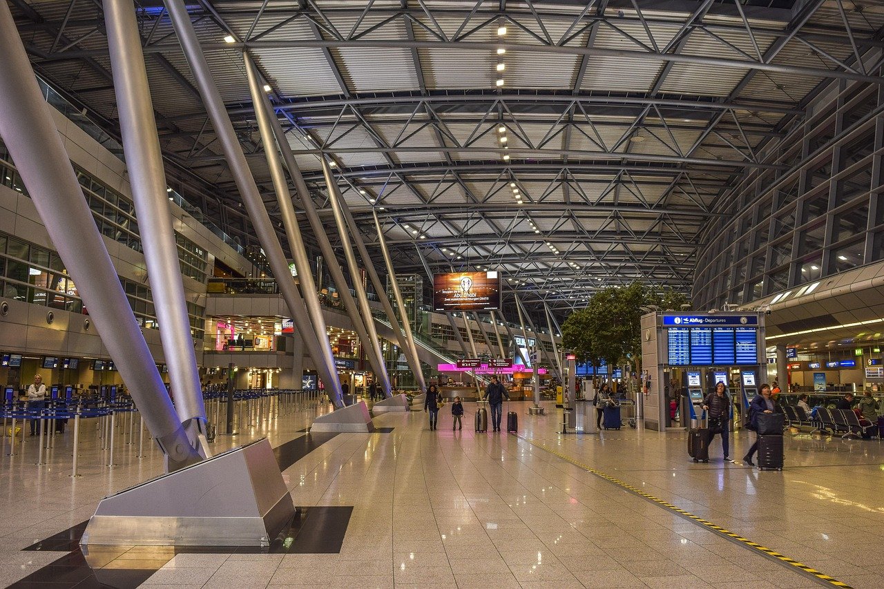 Business traveller with luggage arriving at an airport terminal