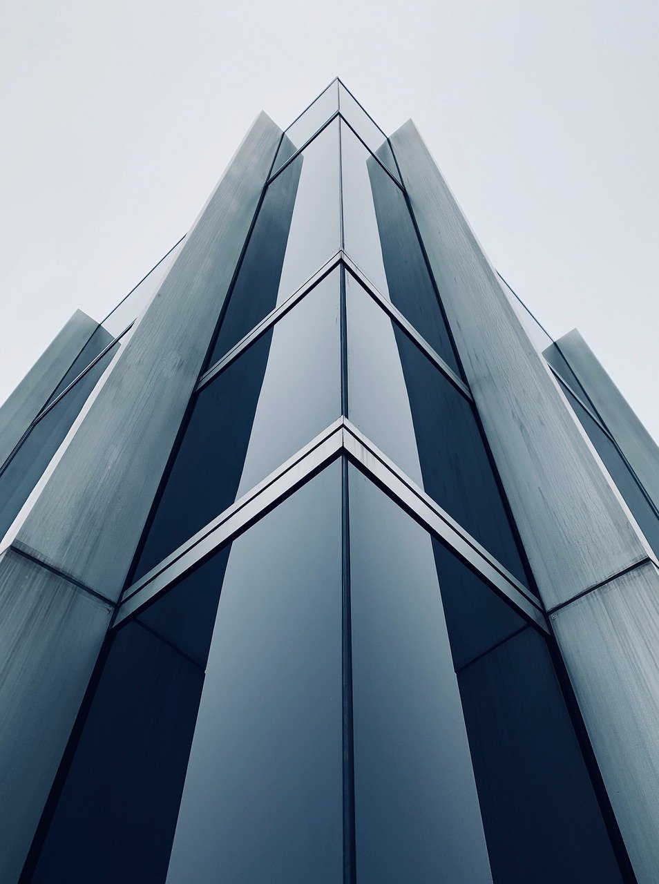 Corporate group van parked outside a modern office building for a business site visit