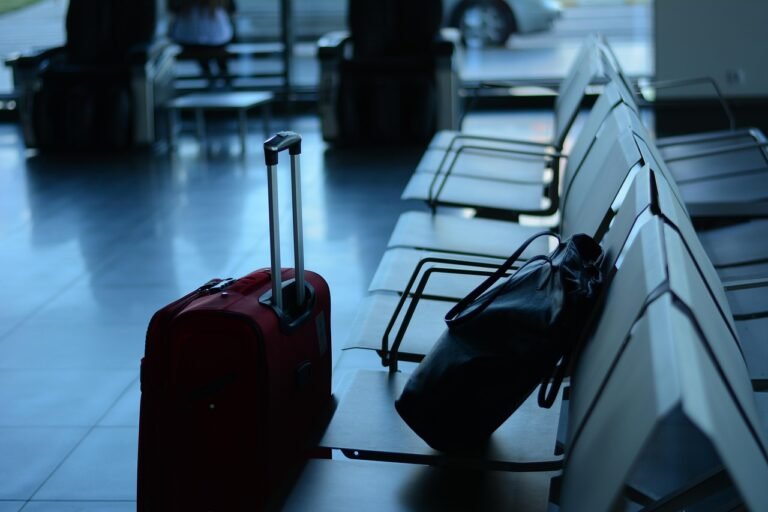 Business traveller with luggage arriving at an airport terminal