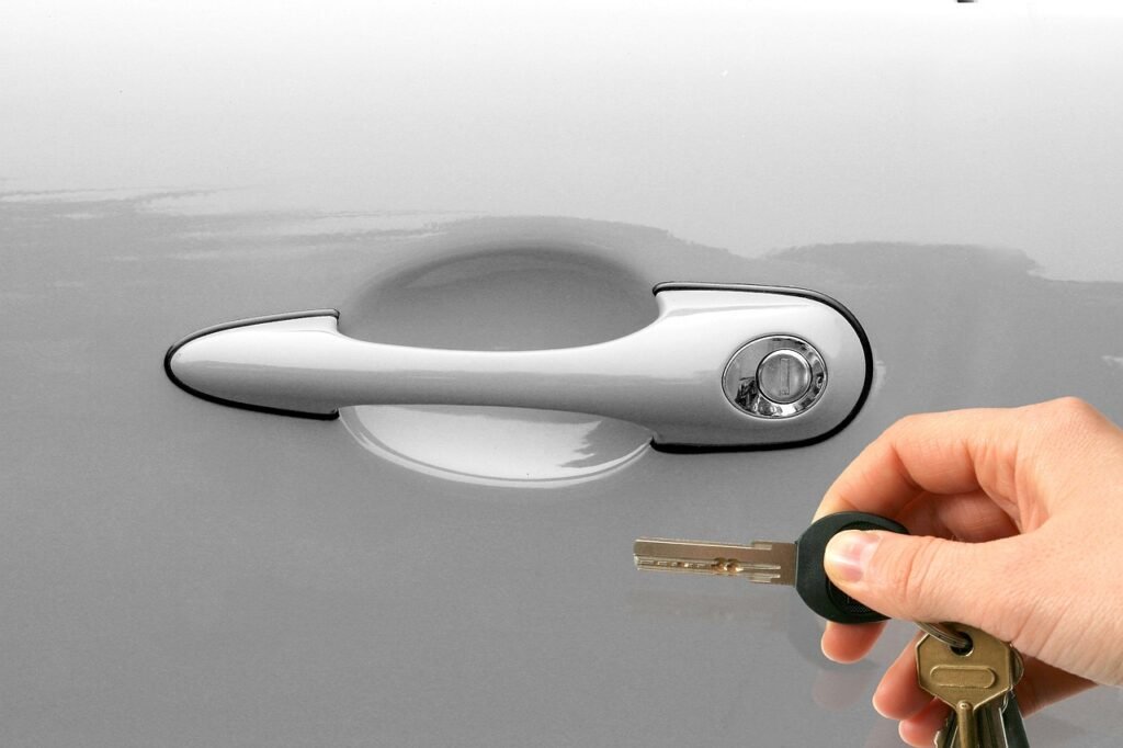 A driver holding open the rear door of a private hire vehicle for a business traveller