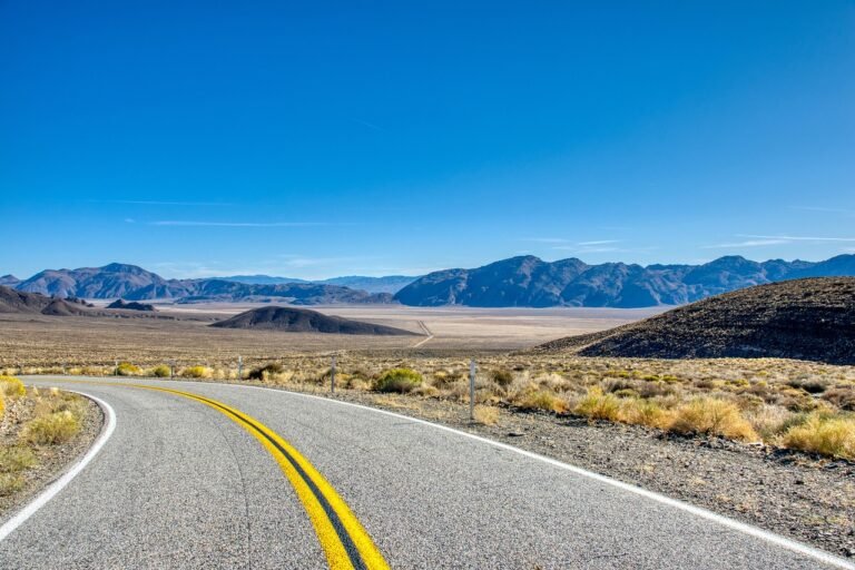 Long desert highway leading toward mountains in north west Saudi Arabia