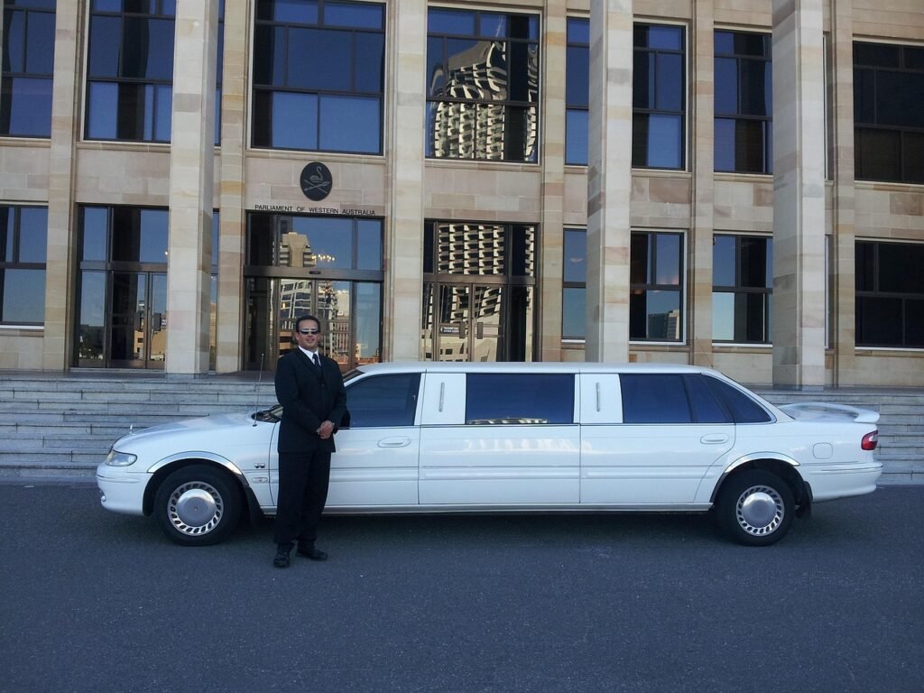 A chauffeur waiting with a name sign, representing a pre-booked pickup