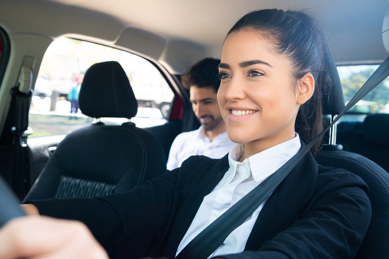 Business traveller being driven through a Saudi Arabian city in a chauffeur-driven car