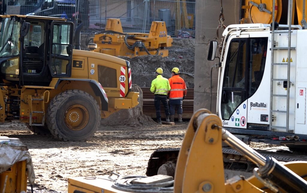 Construction site engineer reviewing plans on site